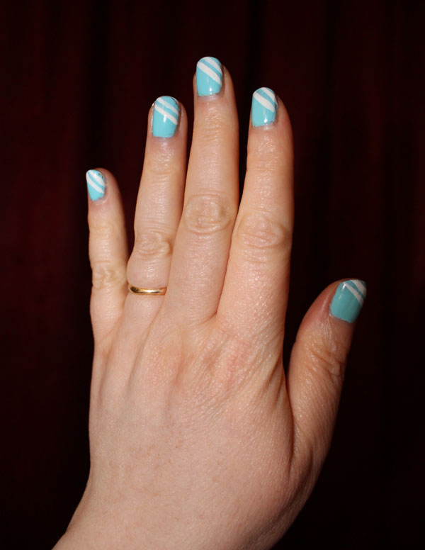Bright blue nail polish with two thin white stripes on tips.