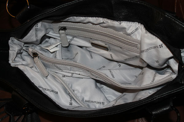 The empty compartments in the handbag.