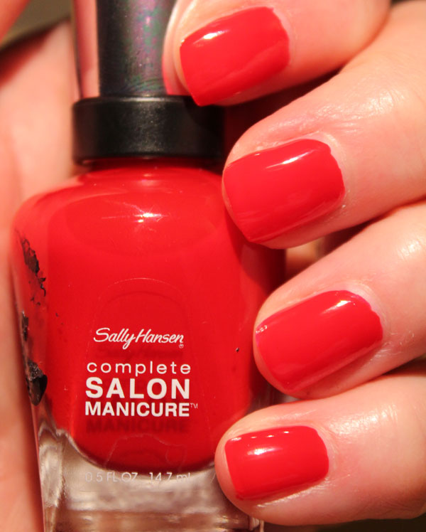 My nails with Sally Hansen's bright red Red My Lips nail polish.